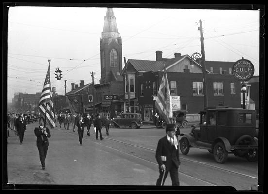 American Legion Parade ; band marching down street; partial view of New York Lunch, Adair Drug