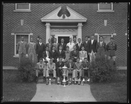 Sigma Chi Fraternity, Lambda chapter; group in steps (trophies, cups)
