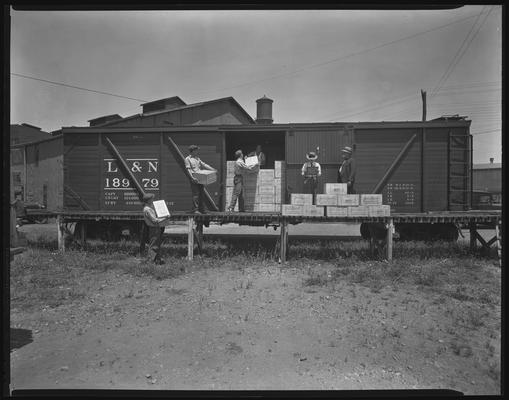James E. Pepper Company (bourbon whiskey distillery); L&N (Louisville & Nashville) Railroad box car, men unloading train