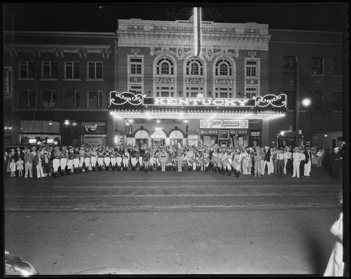 Kentucky Theatre (movie theater), 214 East Main, exterior, street scene; night shot of the Grand Reopening of theater after redecoration of interiors, marching band and onlookers under the lit awning; State Theatre 