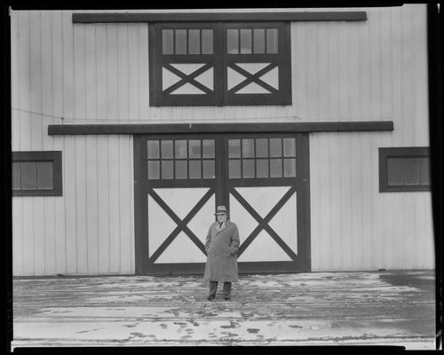 Man in front of barn