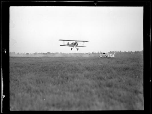 Flying Circus; Airport (airplanes); Airplane passing over car; Cool Meadow