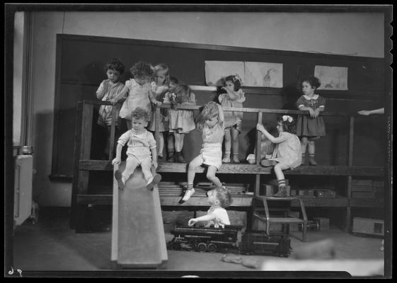 University kindergarten; interior, children on slide