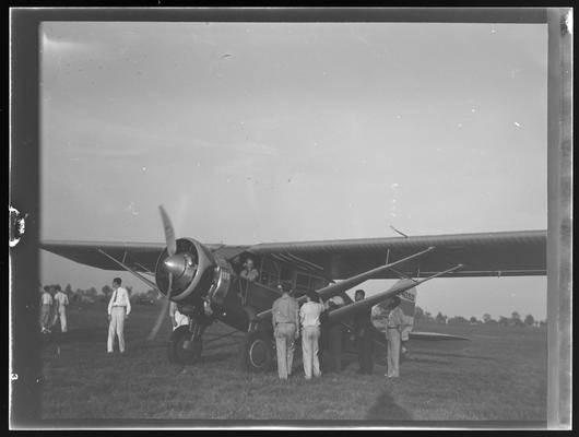 Cool Meadows; Lexington Airport; people standing beside airplane