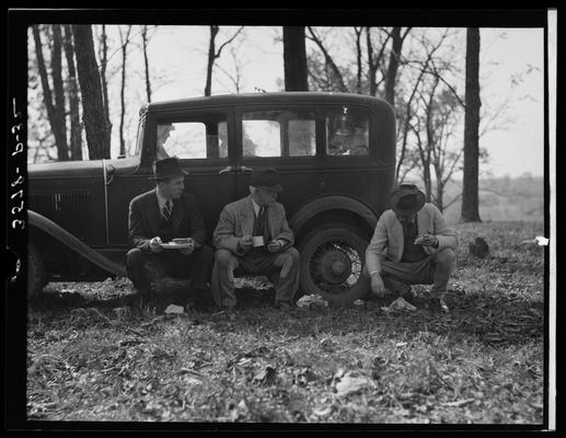 Horse Show, J.E. Madden; three men siting in front of car eating