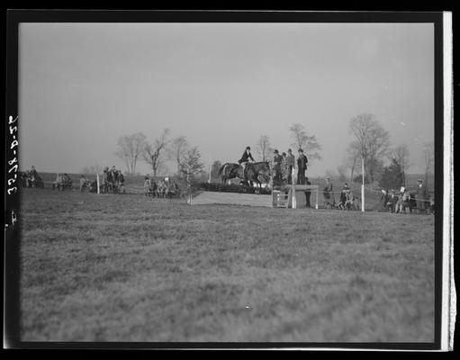 Horse Show, J.E. Madden; rider and horse jumping on track