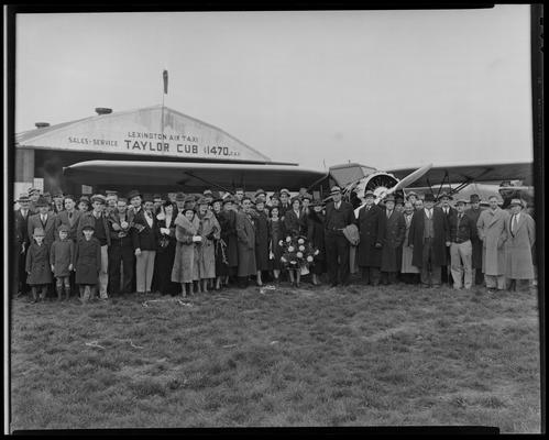 Lexington Airport; large group of people standing in front of airplane; 