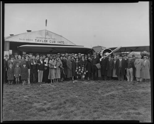 Lexington Airport; large group of people standing in front of airplane; 