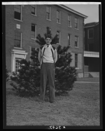 Transylvania College; basketball team; man standing in front of tree and building