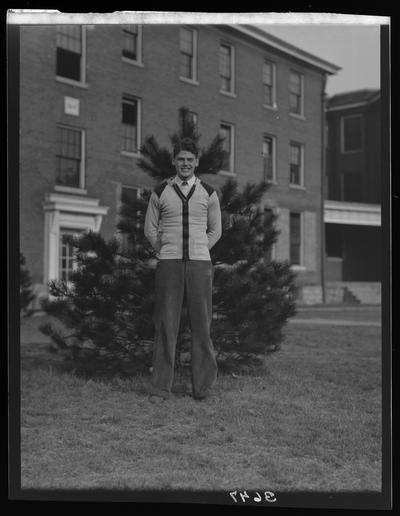 Transylvania College; basketball team; man standing in front of tree and building