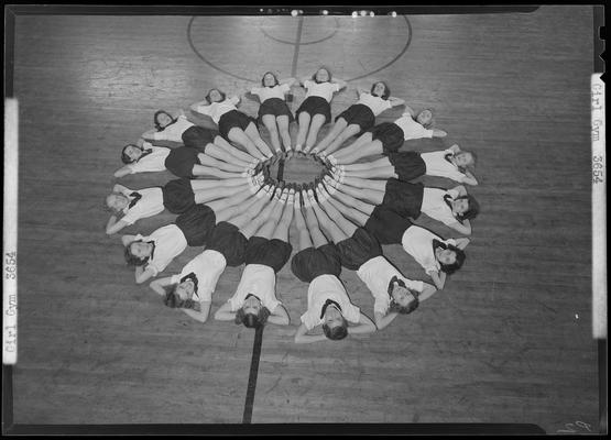 Henry Clay High School (701 East Main) girls gym; sixteen girls laying on basketball court with their feet connected together in the middle