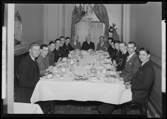 Madisonville Basketball Team; banquet, men sitting at dinner table