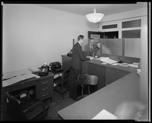 American Life & Accident Insurance Company; interior office, two people talking to teller at window