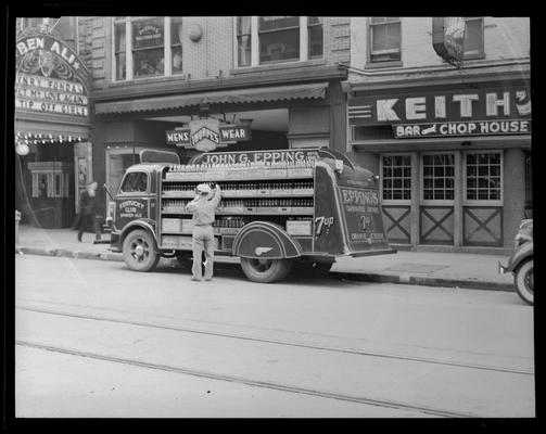 John G. Epping Bottling Works, truck parked in front of Thorpe's Men's Wear (123-127 East Main) and Keith's Bar and Chop House (129 East Main)