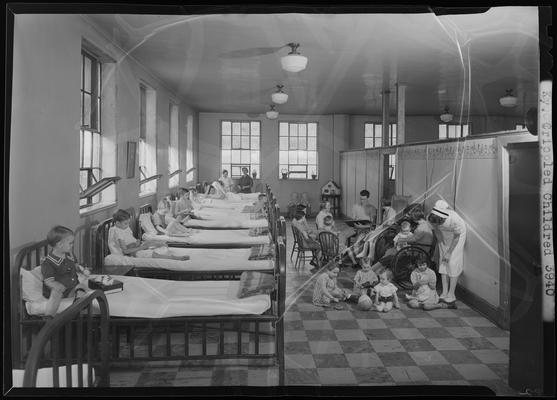 Kentucky Crippled Children's Commission; Good Samaritan Hospital, 310-330 South Limestone; children playing on floor and being read to