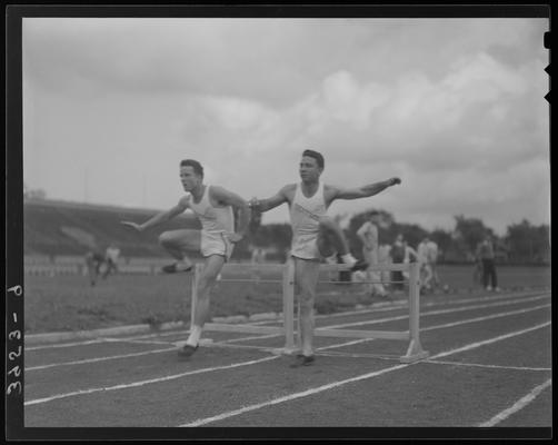 University of Kentucky Track Team (1939 Kentuckian), two team members jumping hurdles