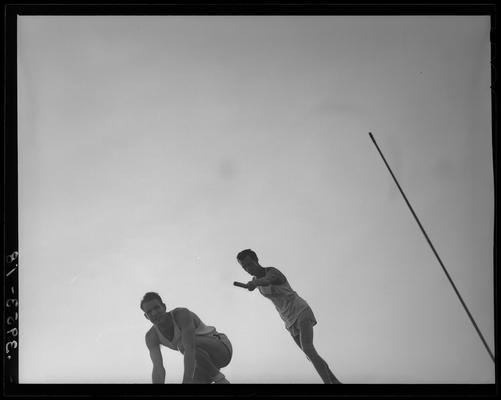 University of Kentucky Track Team (1939 Kentuckian), two team members participating in relay race