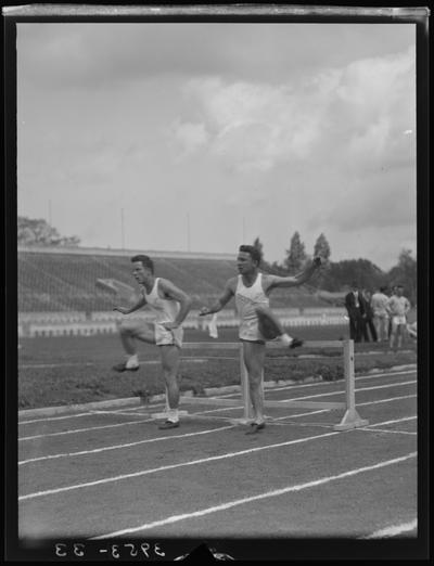 University of Kentucky Track Team (1939 Kentuckian), two team members jumping hurdles