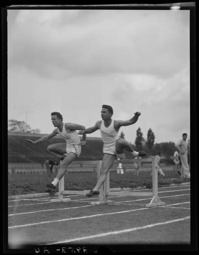 University of Kentucky Track Team (1939 Kentuckian), two team members jumping hurdles