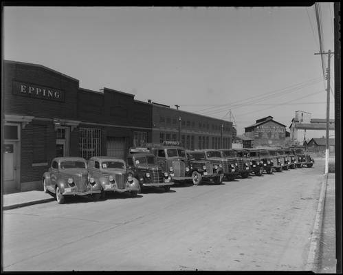 John G. Epping Bottling Works, 264 Walton Avenue; trucks and car parked in front of building