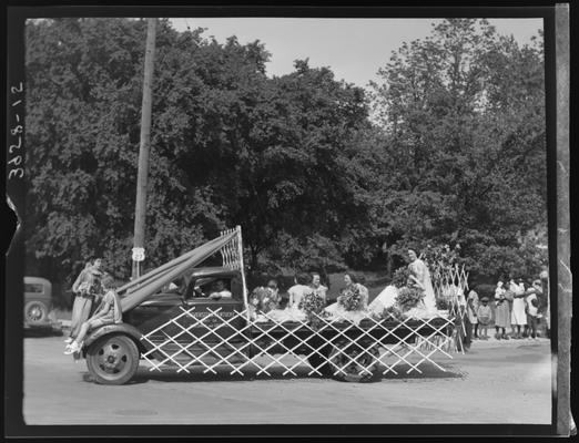May Queen Activities (1939 Kentuckian) (University of Kentucky), girls riding in the back of a University of Kentucky truck, parade