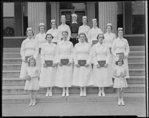St. Joseph's Hospital, 544 West Second (2nd) Street; graduation exercises (nurses), nurses holding diplomas while posing on the steps of hospital building