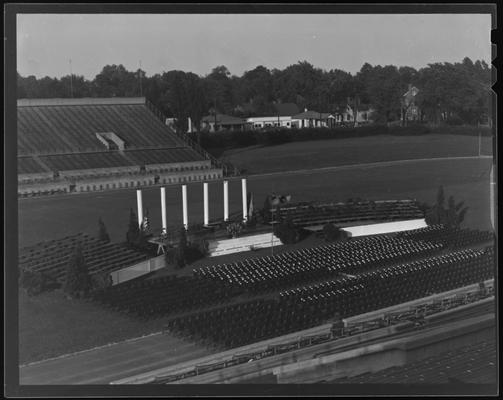 Commencement Exercises, University of Kentucky (1938 Kentuckian), stadium view of commencement stage and empty chairs