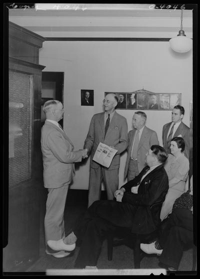 Mutual Benefit Life Insurance Company (167 West Main); salesmen group; two men shaking hands and one receiving award