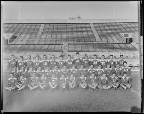 1939 University of Kentucky Football Team; varsity, team members posing for group photo on field