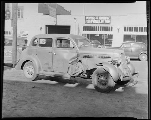 Taylor Bartlett; wrecked car parked in front of Lexington Auto Body Works (413 East Vine), 1938 Clark County Kentucky license plate number 
