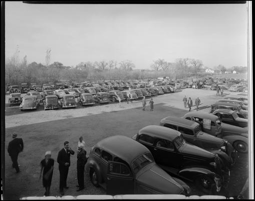 IGA (International Grocers Association) Jubilee; cars parked in parking lot and in the surrounding field