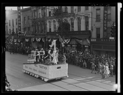 Tobacco Carnival; parade scene, float, Fayette Farm Bureau; Dan Cohen Shoes (258 West Main) and Woolworth (268-274 West Main) in the background