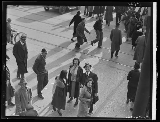 Tobacco Carnival; street scene, people crossing the street