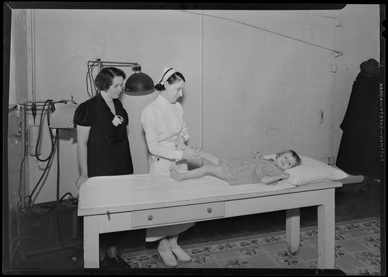 Kentucky Society for Crippled Children, physical therapy; nurse and a woman attending to a small girl on examining table