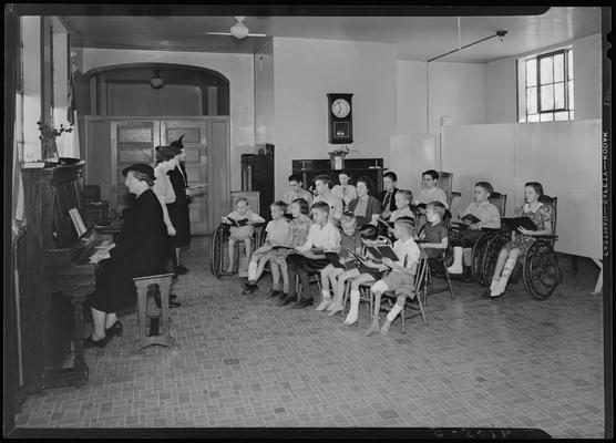 Kentucky Society for Crippled Children; Sunday School, group of children singing along with a woman playing piano and two other women