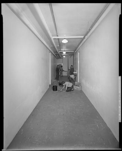 Basement of old University of Kentucky Law building; men working in hallway