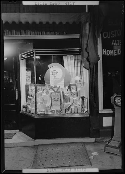 Ellis Drug; 135 North Broadway, exterior window display; photographed at night