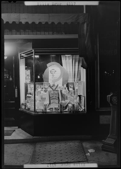 Ellis Drug; 135 North Broadway, exterior window display; photographed at night