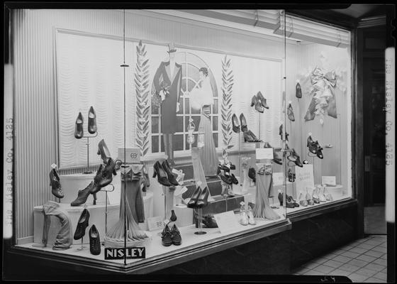 Nisley Company (shoe store), 116 West Main; window display; photographed at night