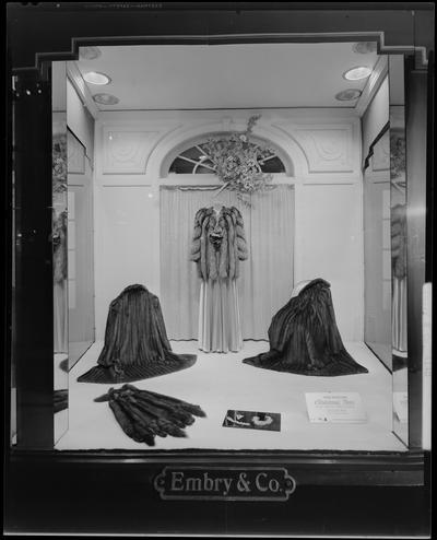 Embry & Company (women's' wear specialty house), 141-143 East Main; window display with fur coats, photographed at night