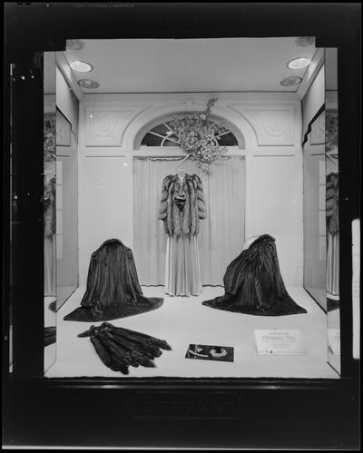 Embry & Company (women's' wear specialty house), 141-143 East Main; window display with fur coats, photographed at night