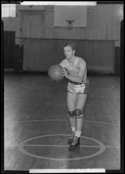University of Kentucky varsity basketball team; individual team member on basketball court, unidentified number, Dannam poised to throw ball