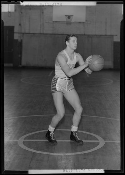 University of Kentucky varsity basketball team; individual team member on basketball court, unidentified number, Goodman poised to throw ball