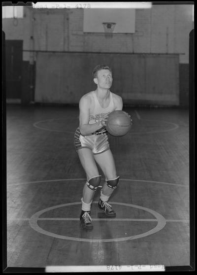 University of Kentucky varsity basketball team; individual team member on basketball court, unidentified number, Head poised to throw ball