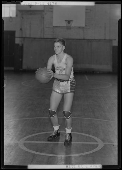 University of Kentucky varsity basketball team; individual team member on basketball court, number 8 (no. 8), Huber poised to throw ball