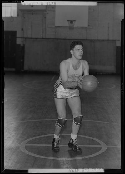 University of Kentucky varsity basketball team; individual team member on basketball court, number 3 (no. 3), Opper poised to throw ball