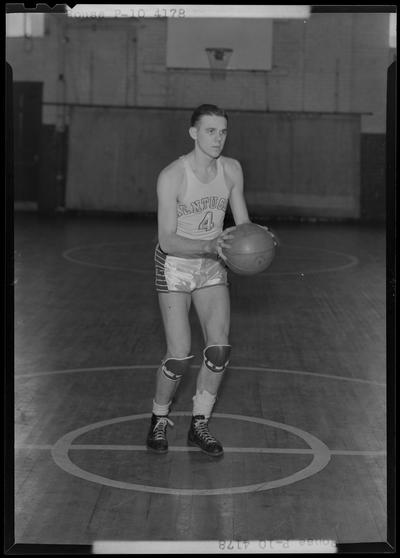 University of Kentucky varsity basketball team; individual team member on basketball court, number 4 (no. 4), Rouse poised to throw ball