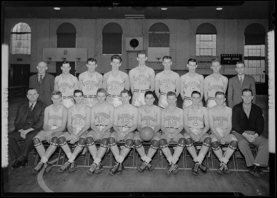 University of Kentucky Varsity basketball team, coach and players posed on the basketball court for a group portrait