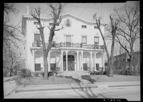 This is Phi Sigma Kappa fraternity house (1939 Kentuckian) (University of Kentucky); exterior front view of house and sidewalk, street address 355, street unknown
