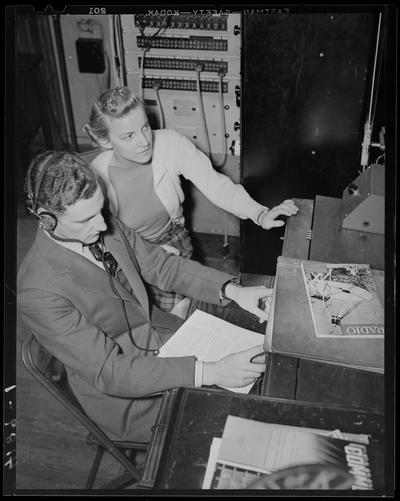 Miscellaneous (1939 Kentuckian) (University of Kentucky); woman standing next to a man operating a radio device